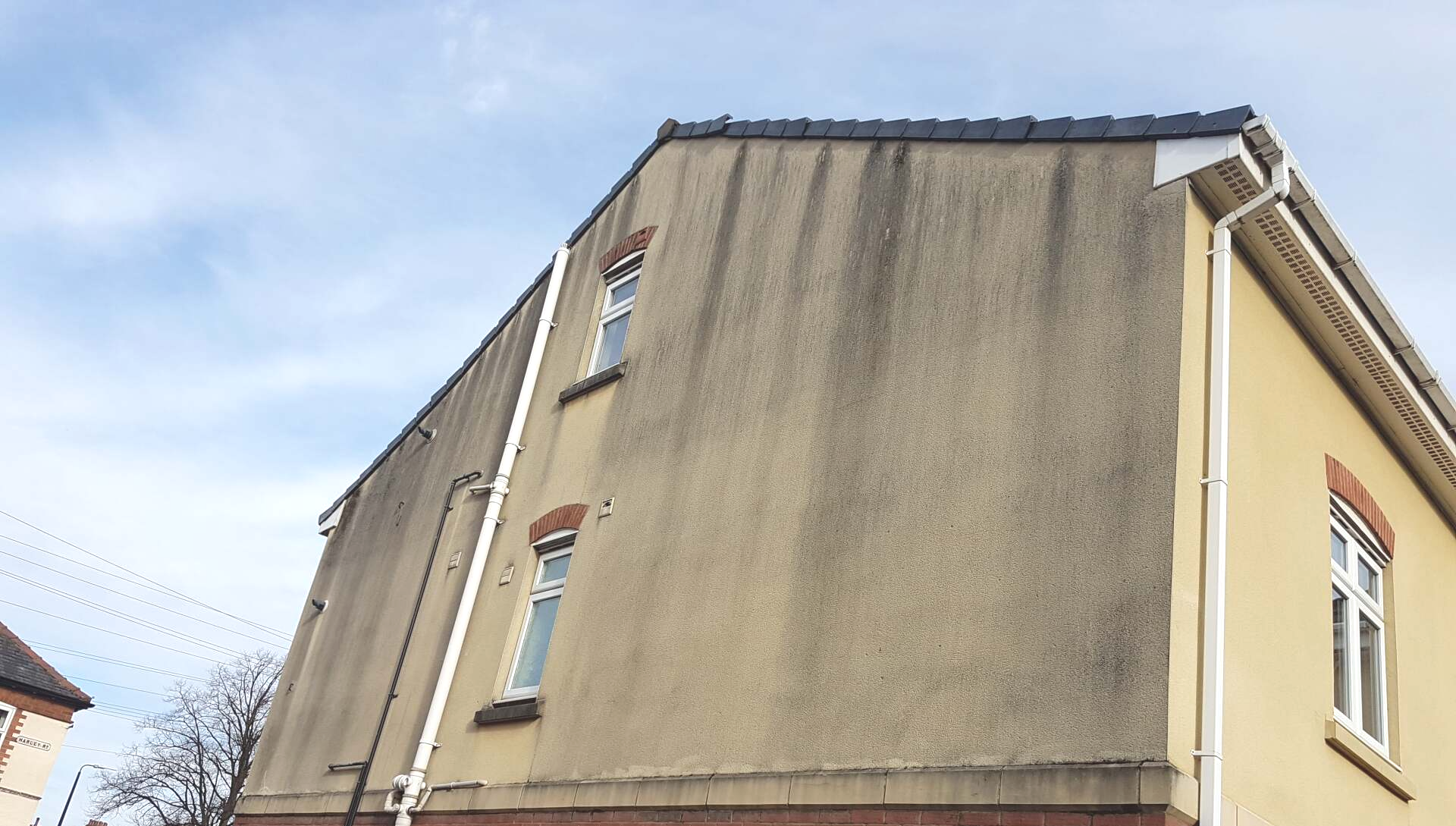 Dirty rendered wall before soft wash cleaning