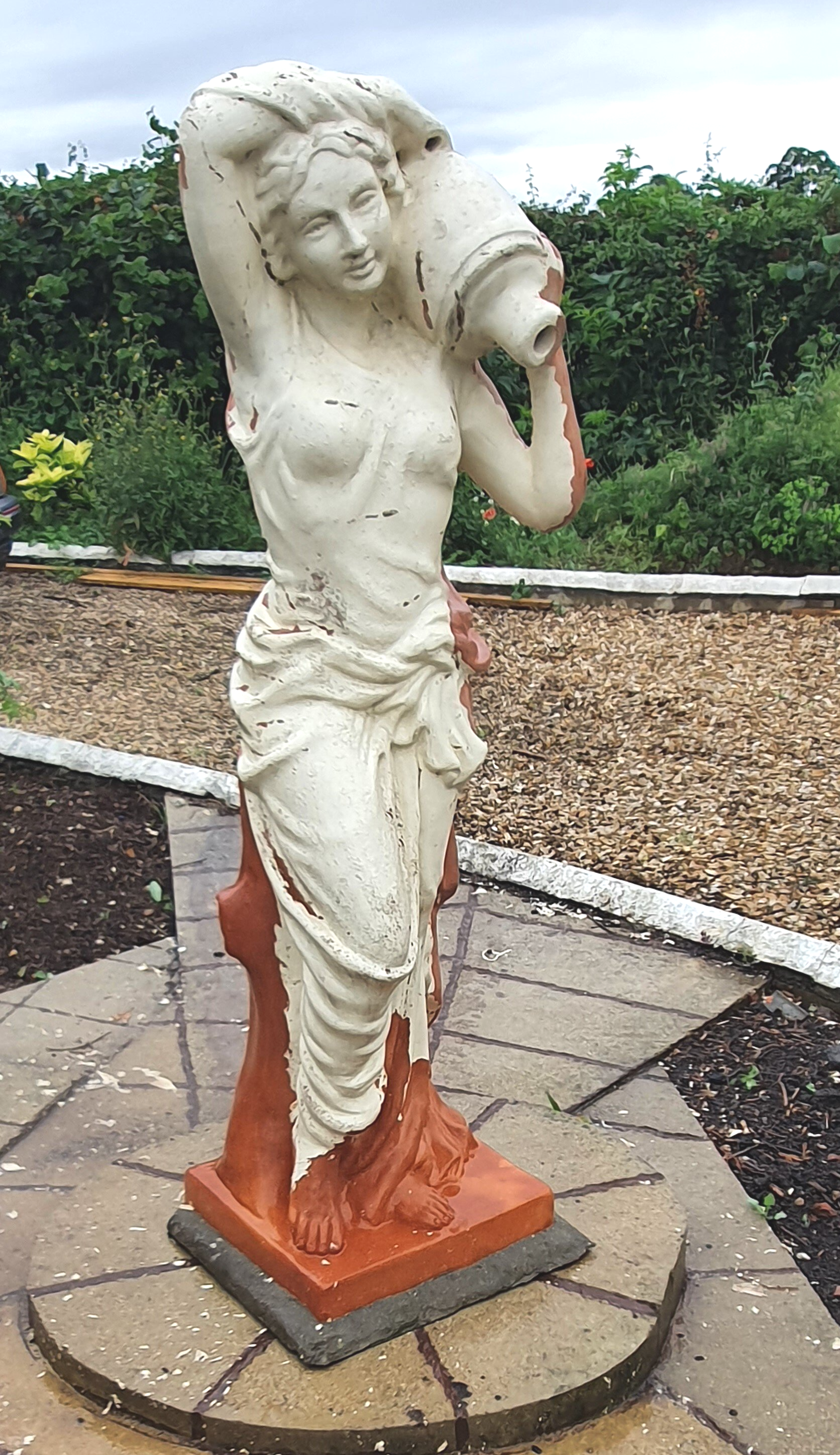 Terracotta statue with peeling paintwork