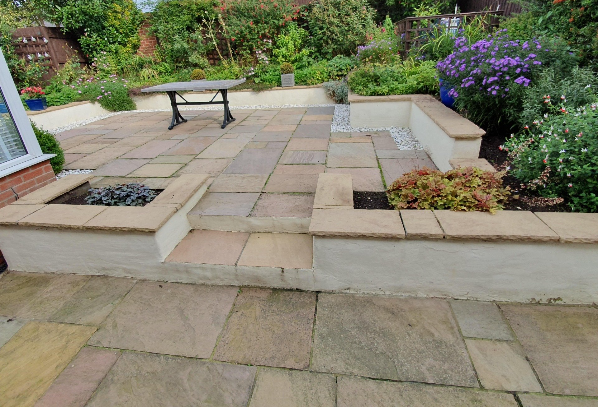 Indian sandstone patio area with lichen & Black Spot infestation before soft wash cleaning
