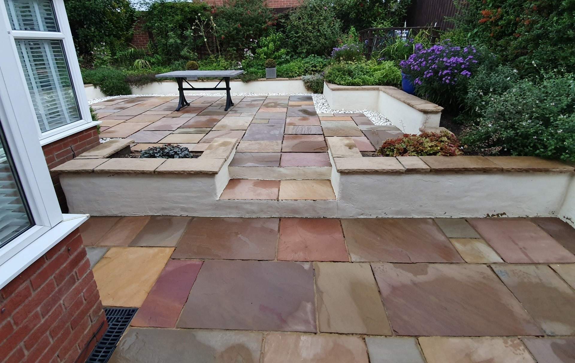 Indian sandstone patio area with lichen & Black Spot infestation after soft wash cleaning