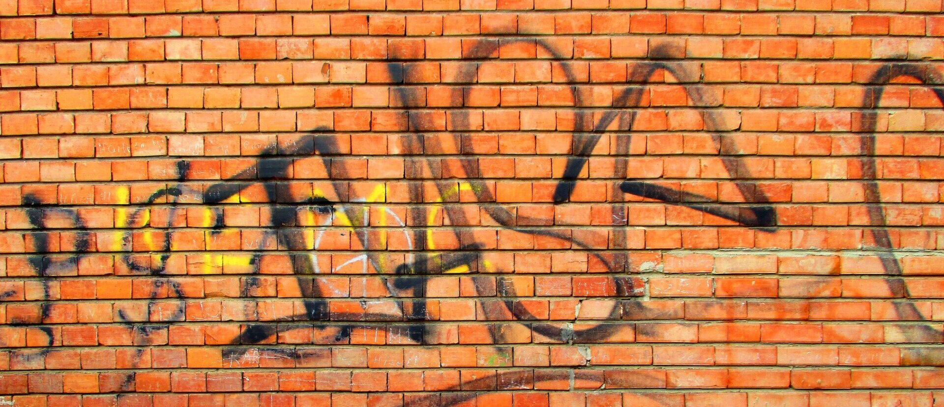 Brick wall covered in graffiti