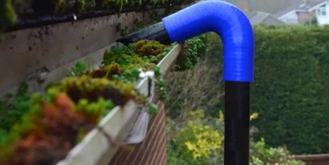 Gutter vacuum removing moss from gutters