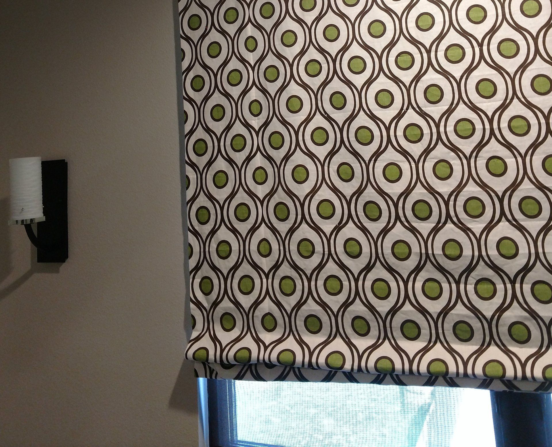 Window treatment in Kravet contemporary style fabric with avocado green, brown and white colors.