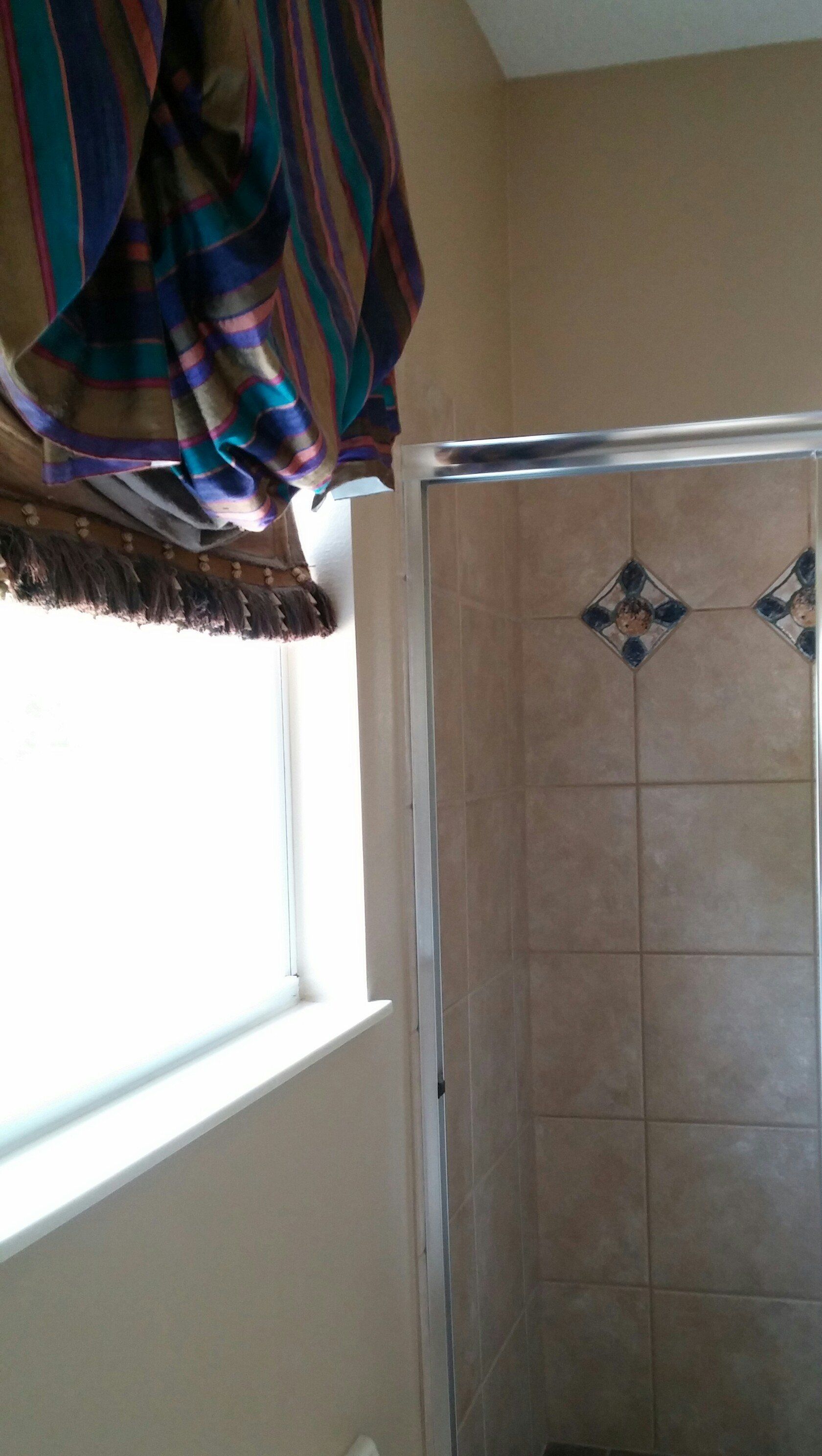 Custom striped silk shade in vibrant colors that match tile inserts.