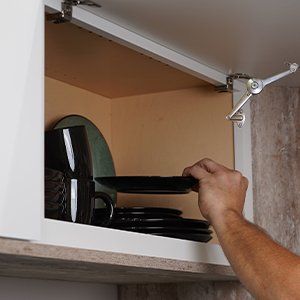 Ideal cabinetry garage door wall cabinet example with horizontal lifting door.