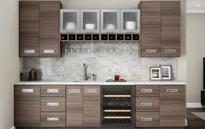 Ideal Cabinetry clean and contemporary wet bar with flat panel cabinets and wine cubes.