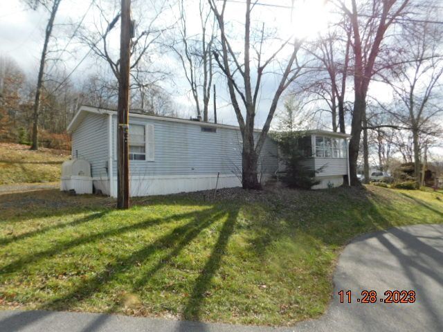 SALE PENDING - WONDERFUL LOCATION, YOU DO NOT PAY LOT RENT! You are an owner (shareholder) and pay monthly dues of $275/month) Charming mobile home park w/ small pond. Attractive home features 2 bedrooms, 2 full baths, 10 x 13 open porch, 12 x 16 screened porch, 12 x 12 utility shed & carport.   ASKING PRICE:  $74,900   PM-111231   