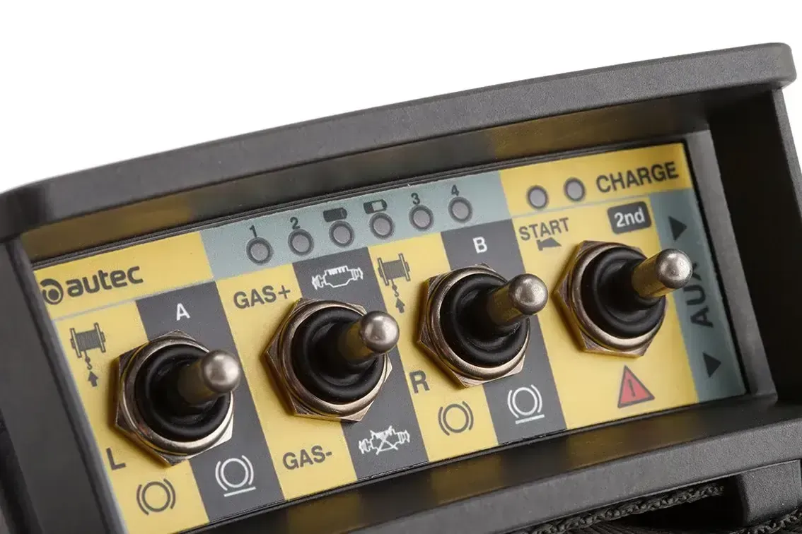 An AUTEC SK4 transmitter, showing 4 toggle switches