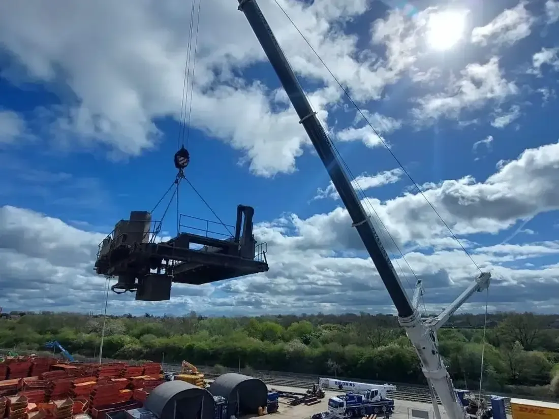 Old crane bring removed through the roof