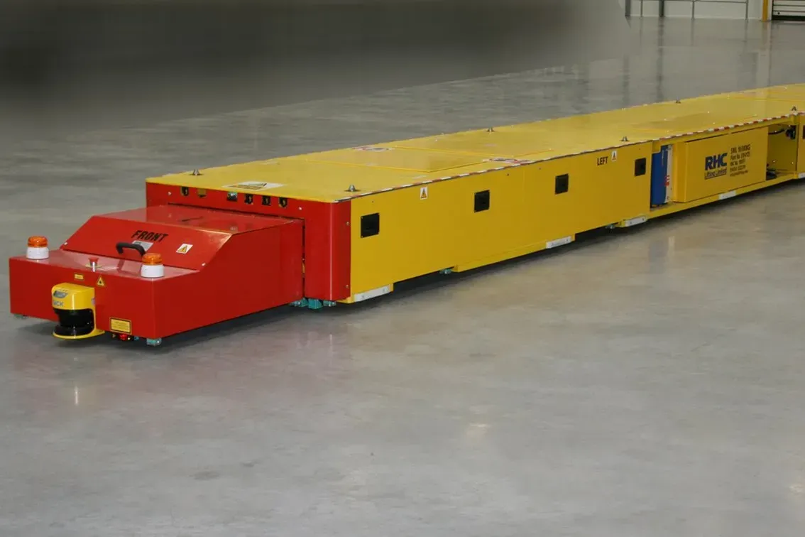 An automated guided vehicle positioned on the floor