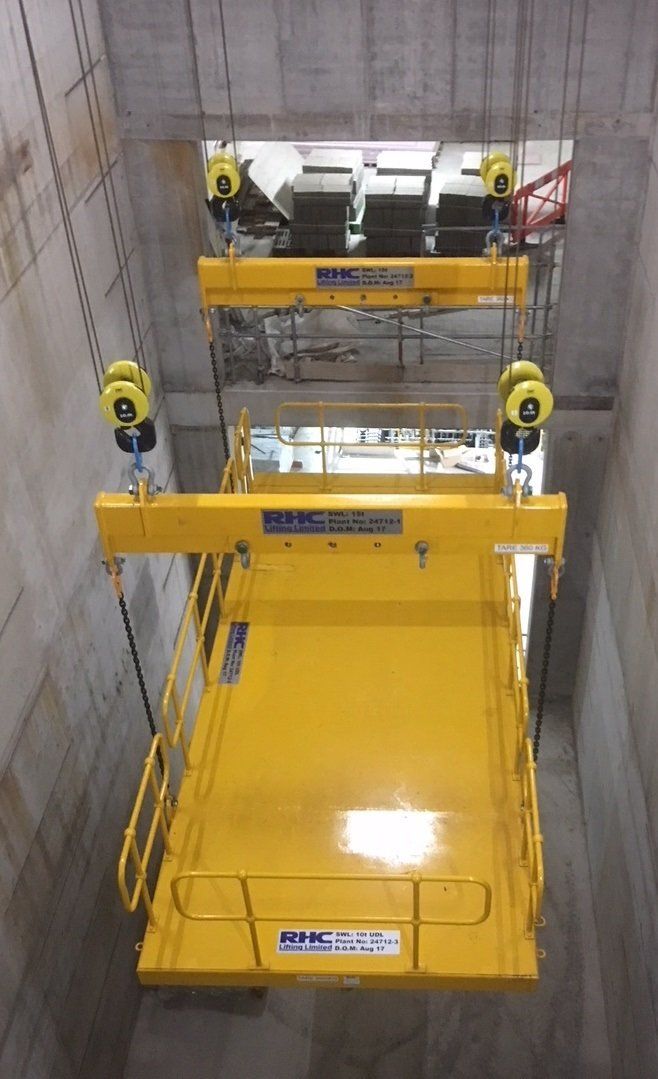A yellow material lifting solution being lowered down