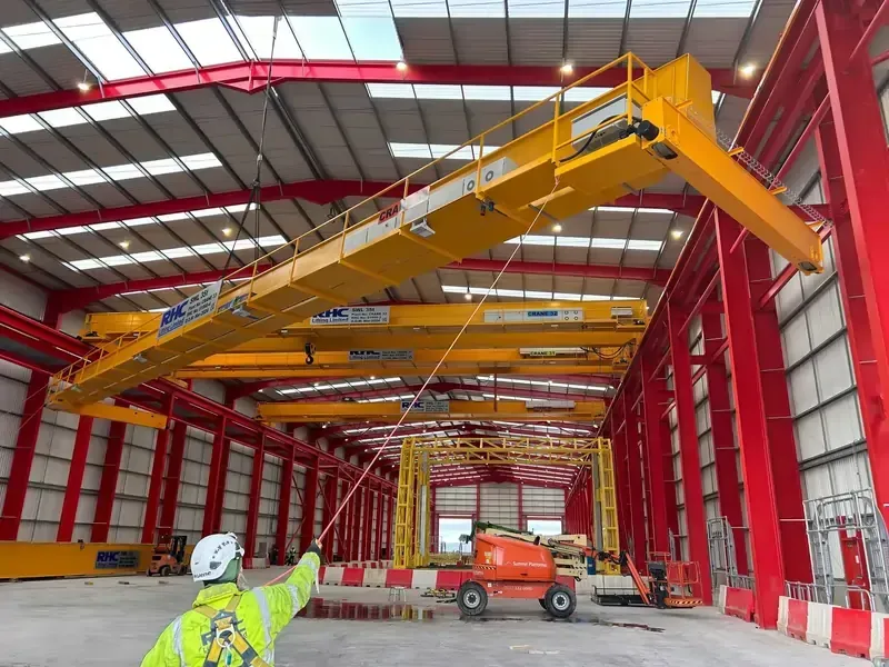 An engineer assisting with the installation of a gantry beam