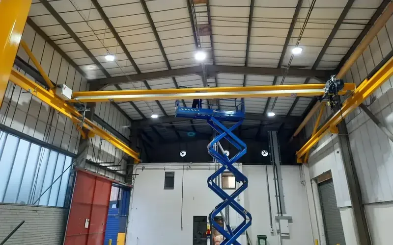 An RHC engineer using a scissor lift to work on a gantry beam