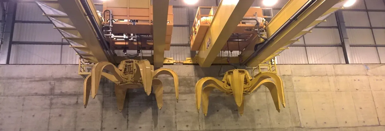 Two waste handling grab cranes