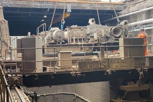 An old waste handling crane, covered in dust and grime