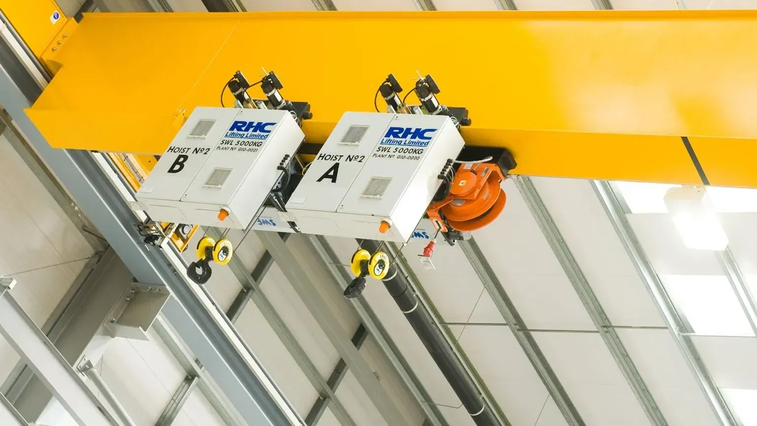 Close up of 2 SWF Krantechnik hoists on a yellow gantry beam