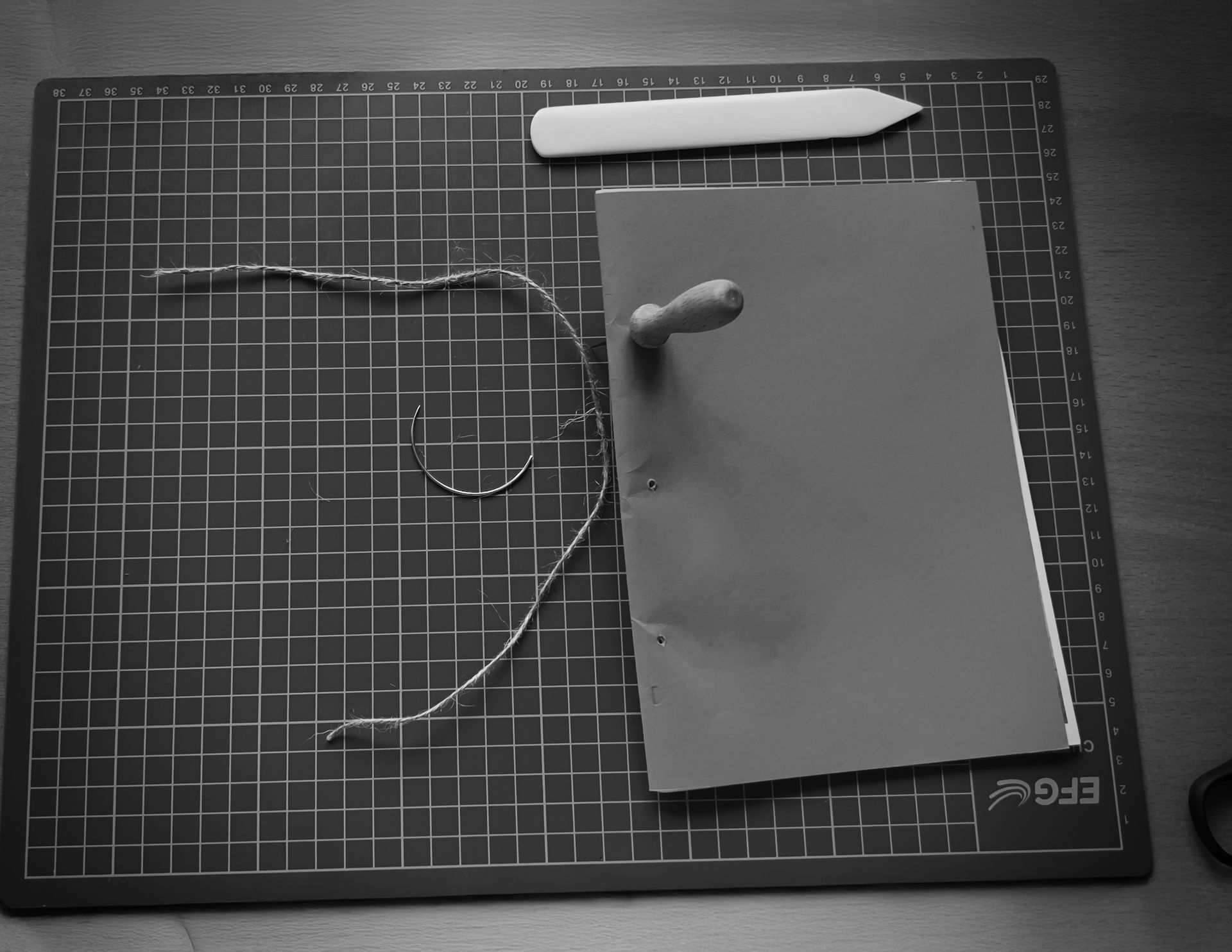 Handmade book made from family photographs, shown during the creative process on a work surface.