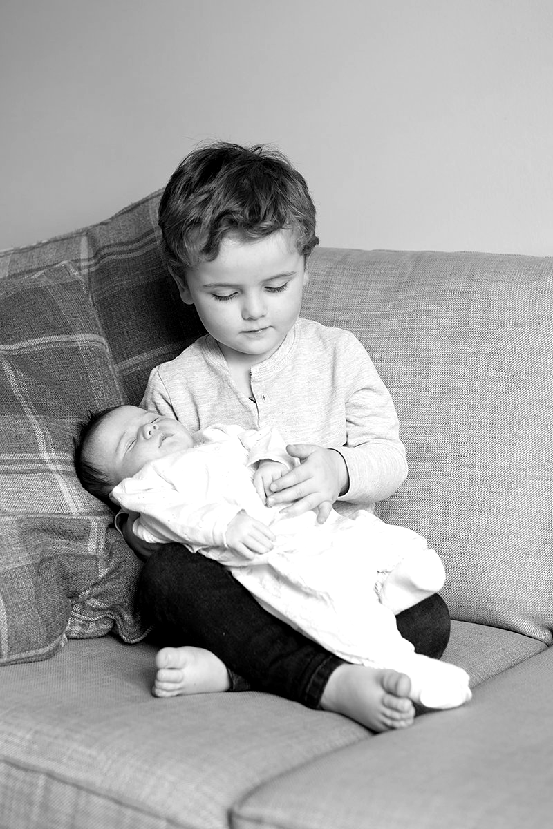 little boy holding baby