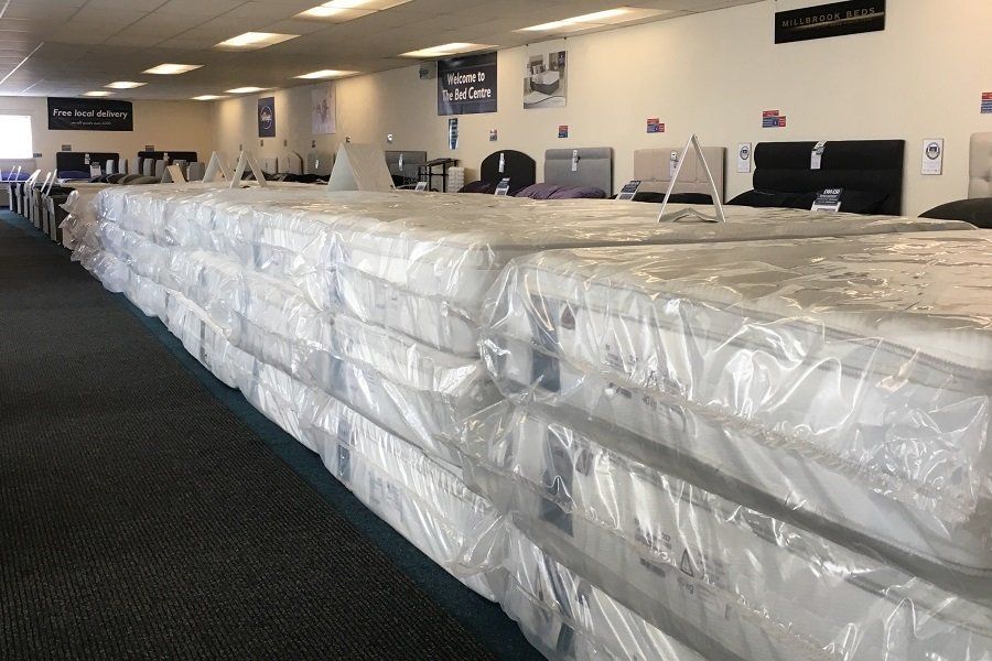 A picture of many stacks of stock mattresses bought in bulk at discounted prices