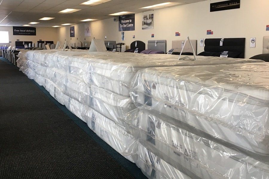 A picture of many stacks of stock mattresses bought in bulk at discounted prices A picture of many stacks of stock mattresses bought in bulk at discounted prices