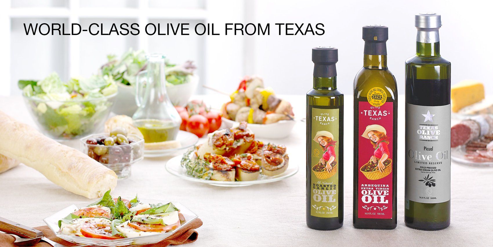 Texas Olive Ranch Extra Virgin Olive oil. Texas Olive Ranch Extra Virgin Olive Oil and flavor infused Texas olive oil on table top-1