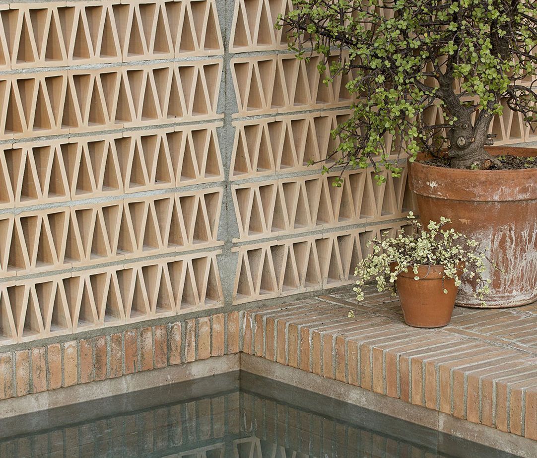 wall made from archi.cotto in the garden of this house