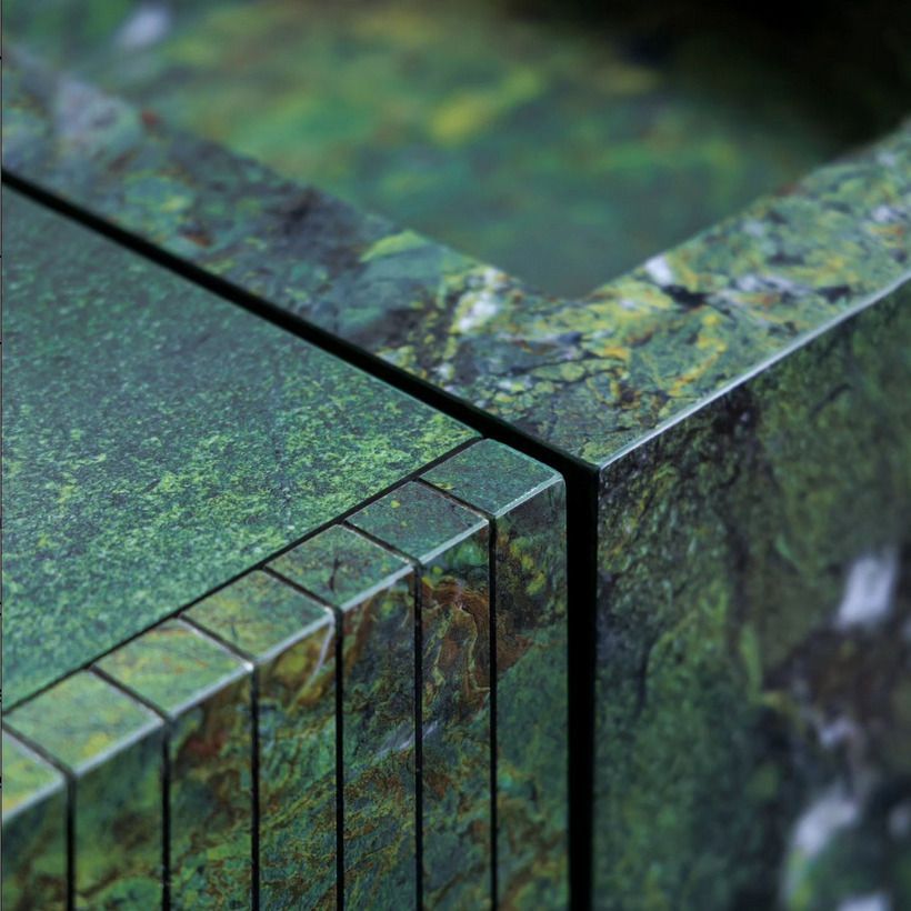 Close-up detail of a green stone countertop, highlighting the intricate natural textures and shades of green.