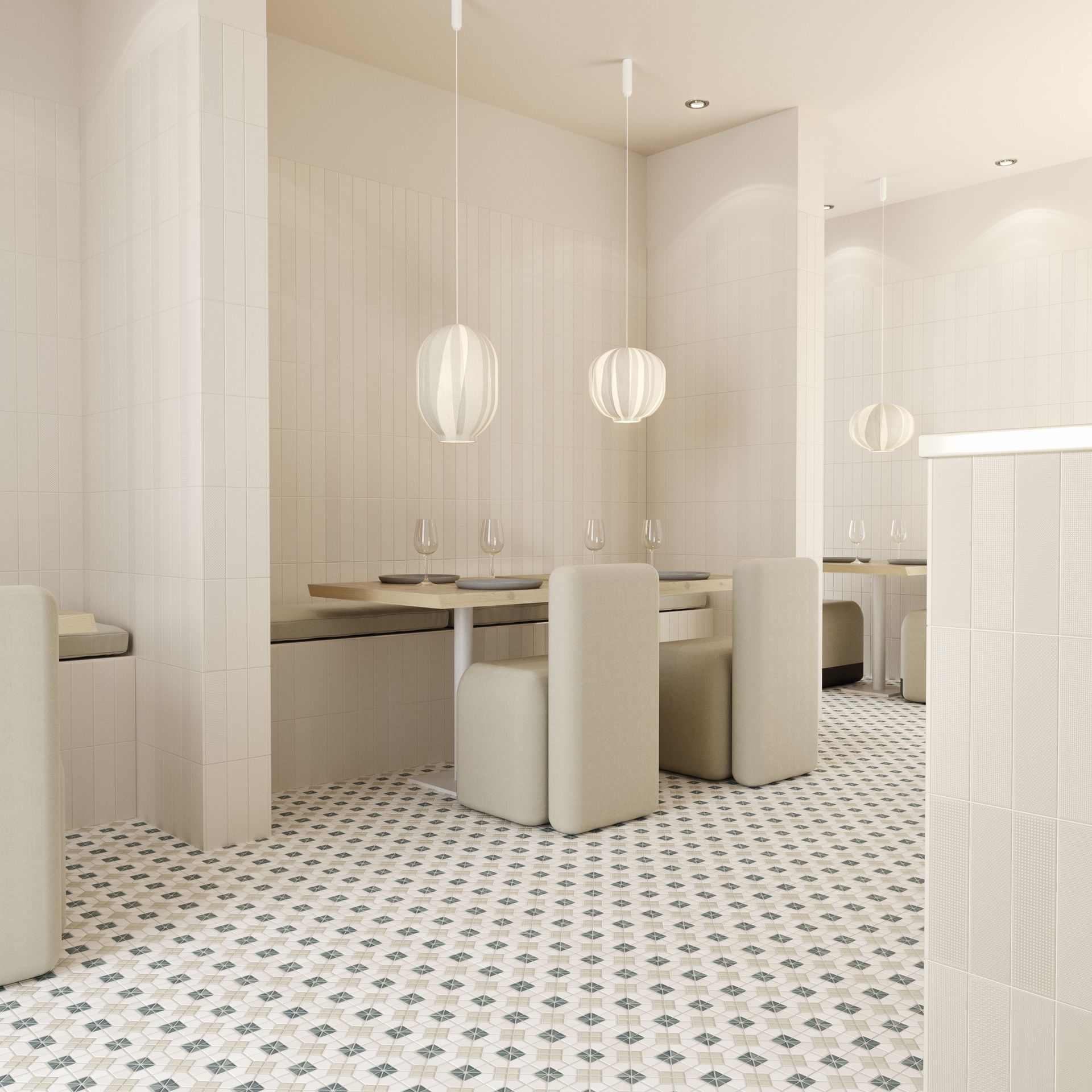 Interior of a minimalistic restaurant with small geometric floor tiles in white and blue and white vertical tiles on the walls.