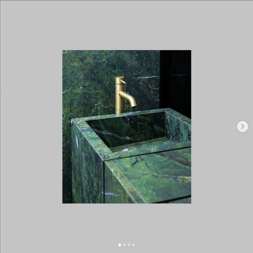 Green bespoke sink close up used in a green marble themed bathroom