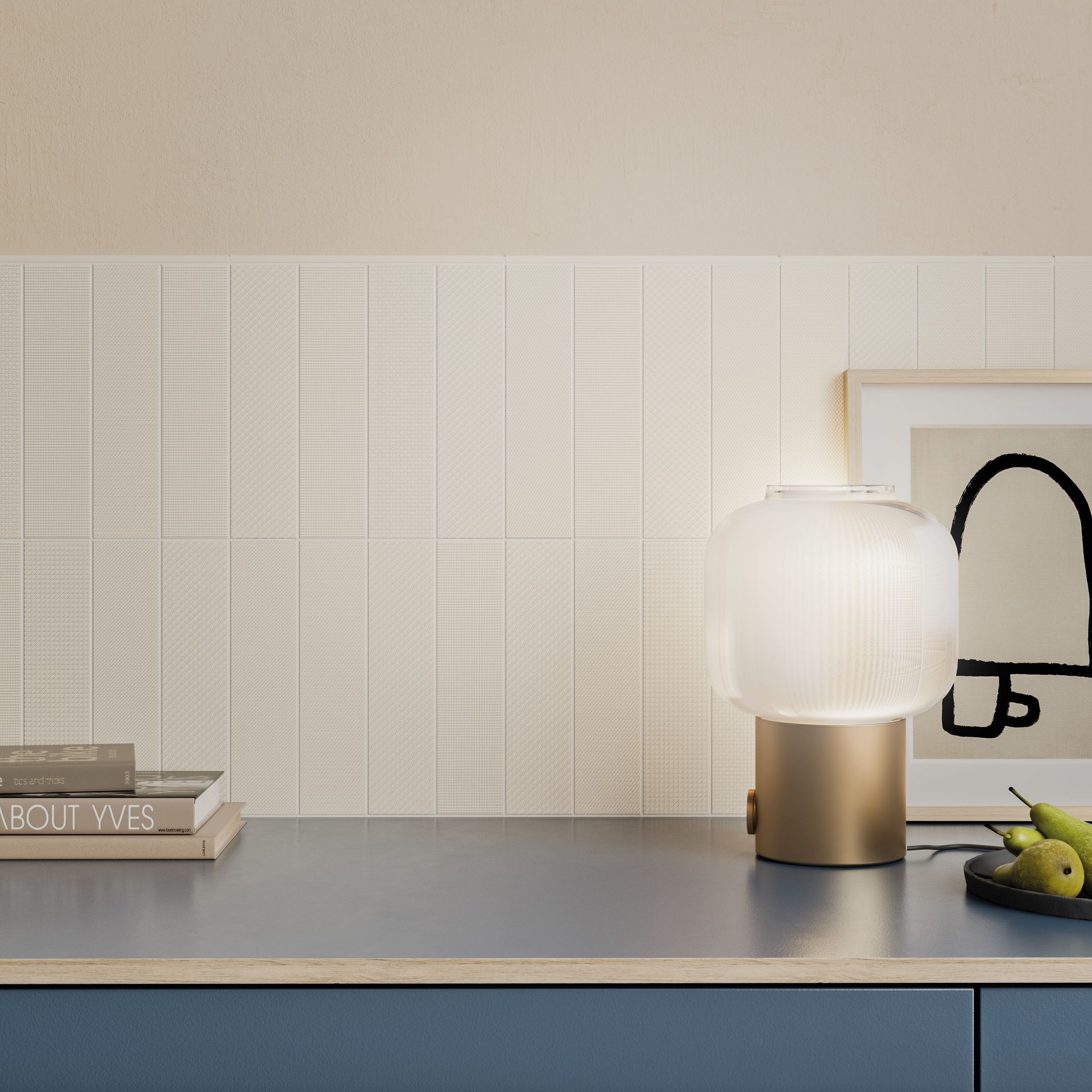 a light coloured tile with a side lamp and some wall designs and a plate of fruit