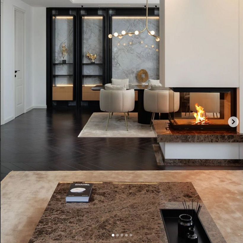 Black chevron wood effect floor tiles that contrast with the rest of the white painted room