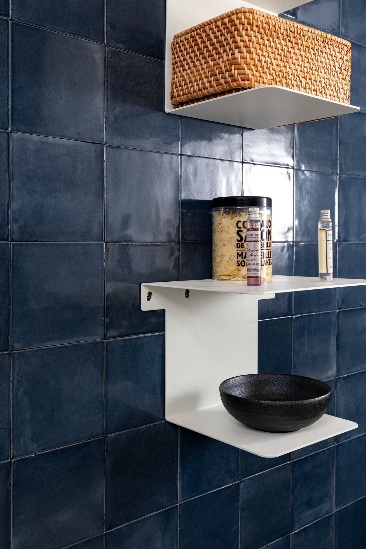capri blue on a bathroom wall with 2 products infront of it