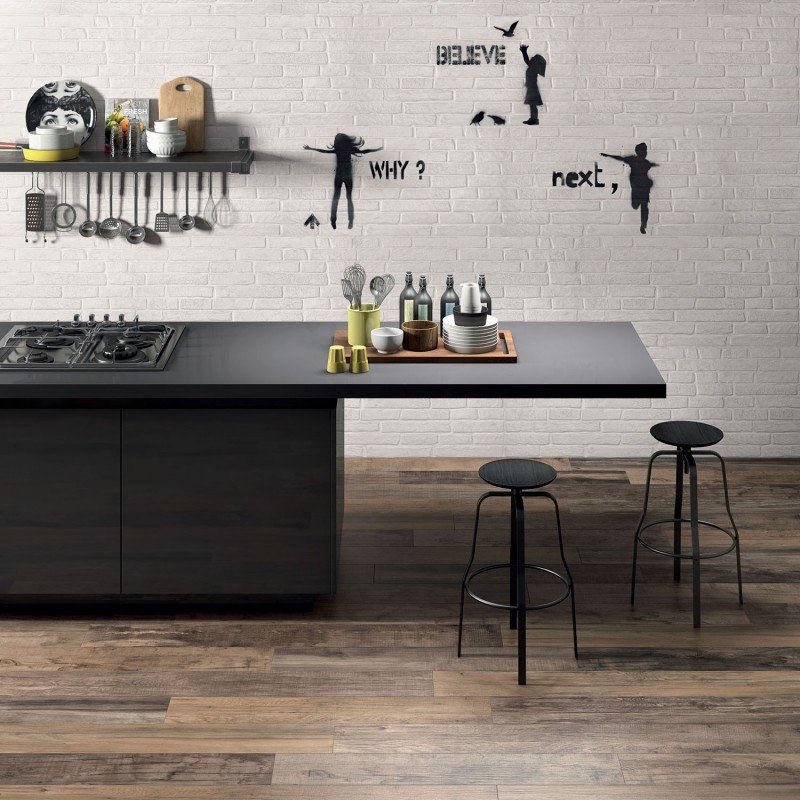 wooden effect tiles and a black countertop with black stools