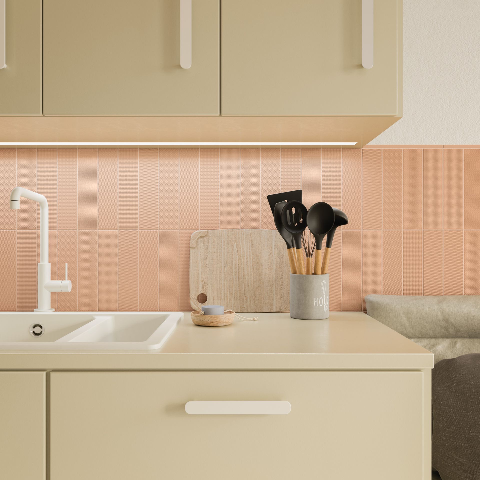 a light coloured kitchen design with a couch next to it