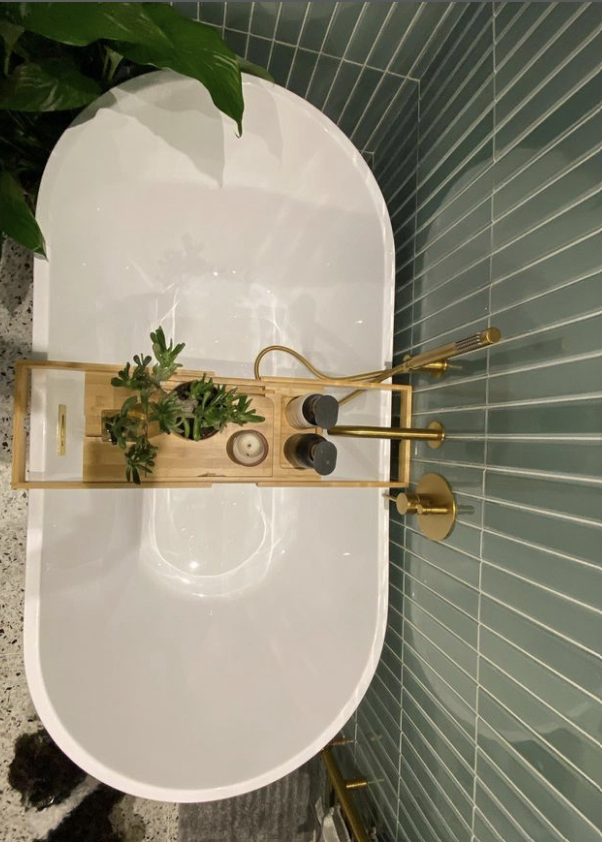 Flaut Green above a white bath in a bathroom with a bath tray ontop of it