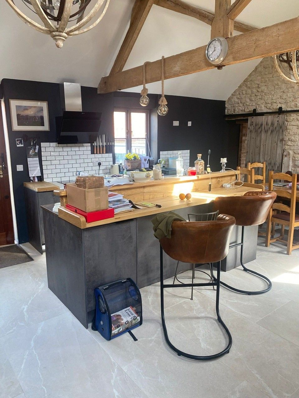 Kitchen room shot with marble floor tiles and a wooden countertop island