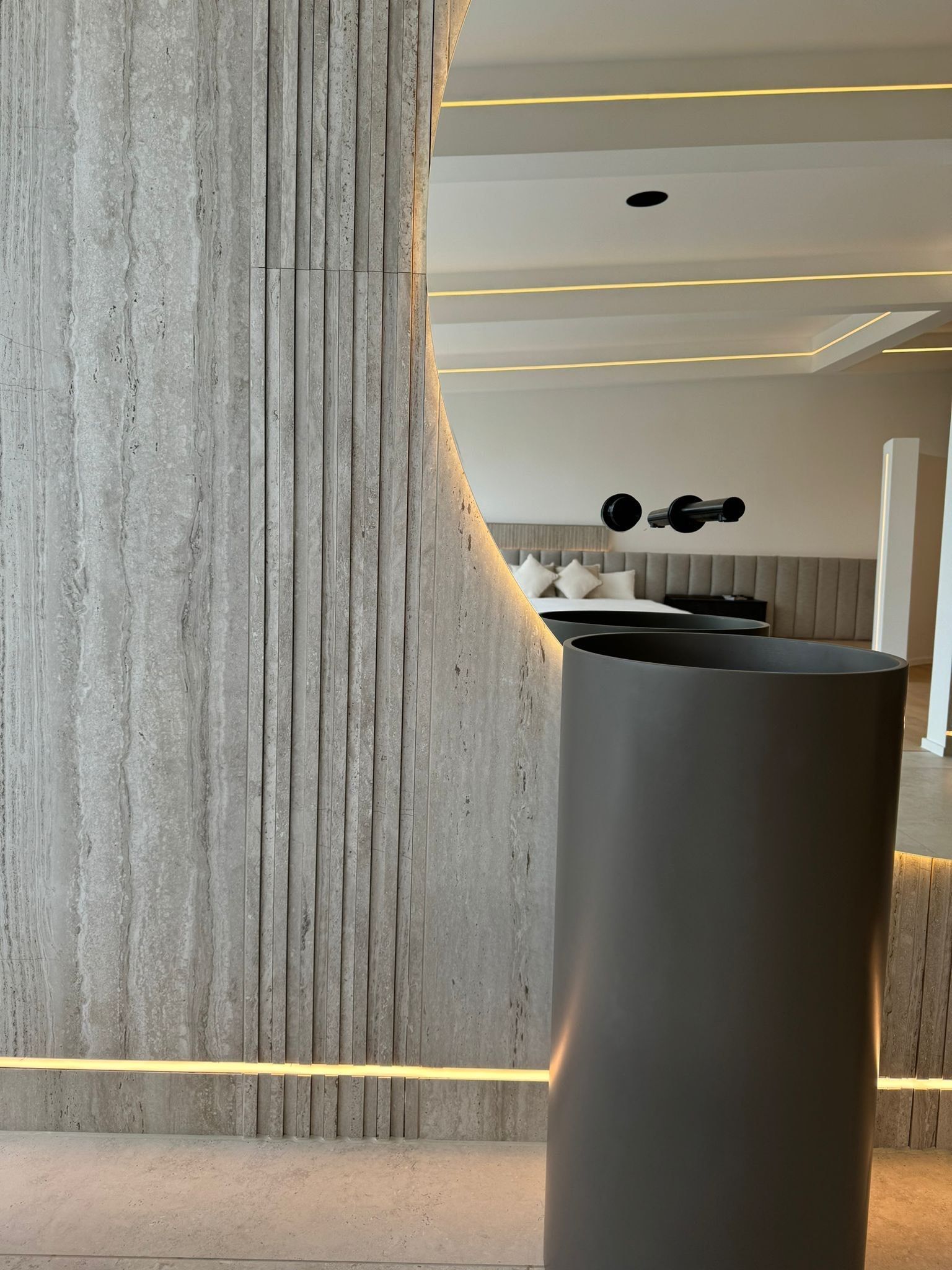 close up to travertine fluted wall tile in the on suite