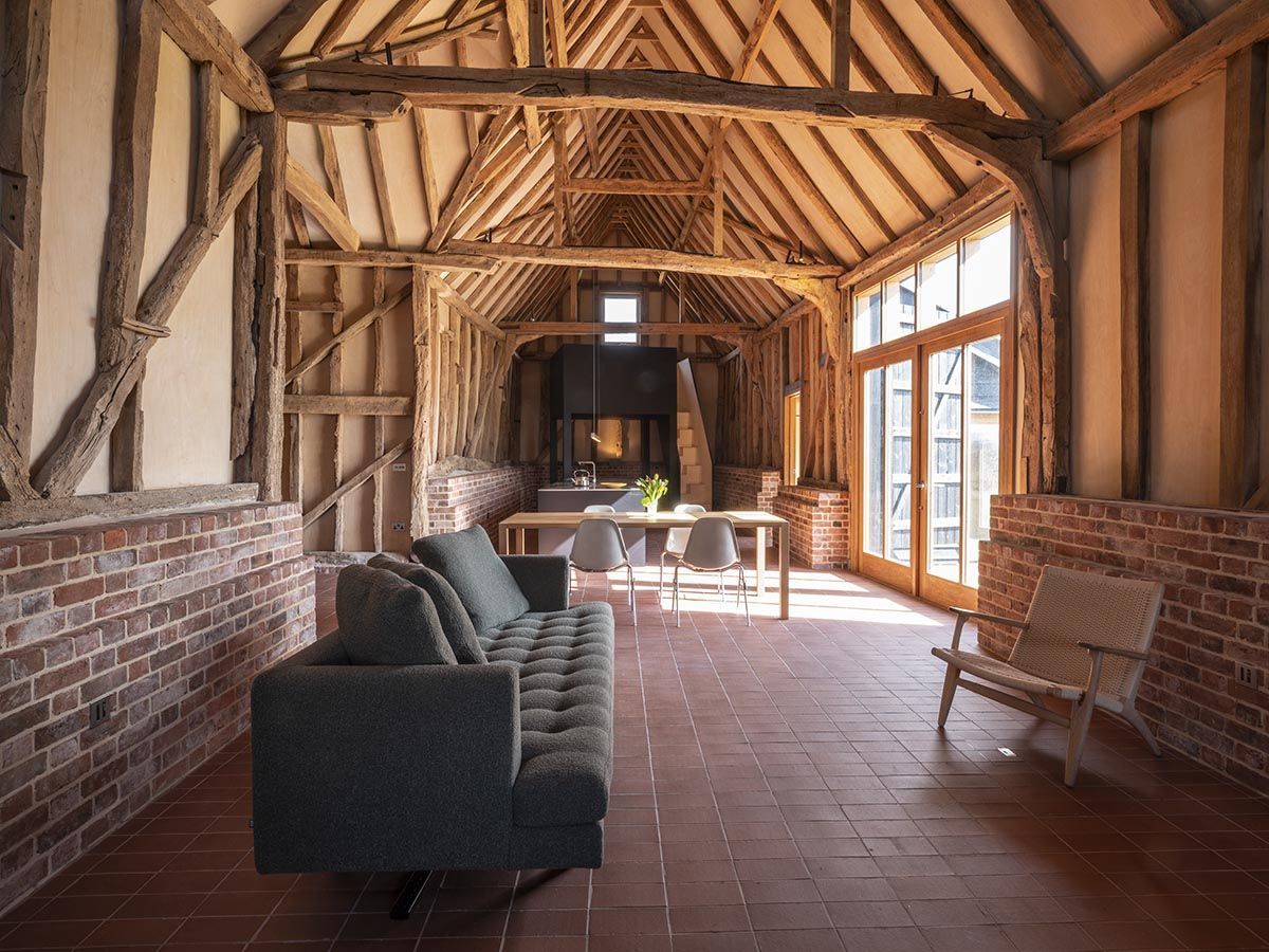 bricklike tiles on the floor/walls and sofa in the middle