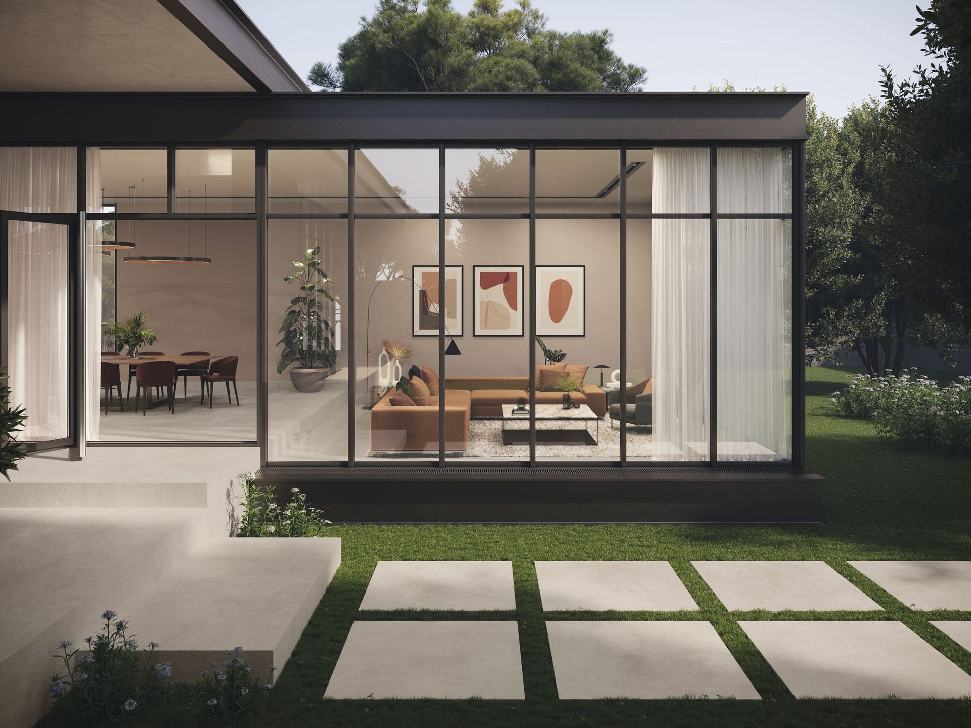 Modern living room with floor-to-ceiling glass windows, showcasing an open interior with stylish decor and framed abstract artwork on the walls. Outdoor stepping stones lead up to the entrance, surrounded by a lush green lawn