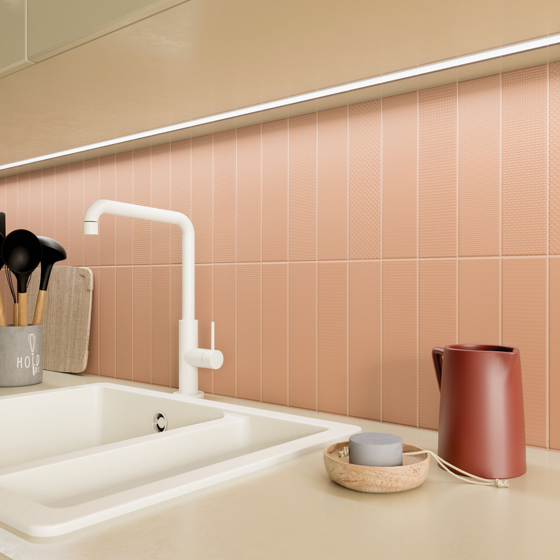 a peach coloured tile with a orange jug and a white brass ware sink