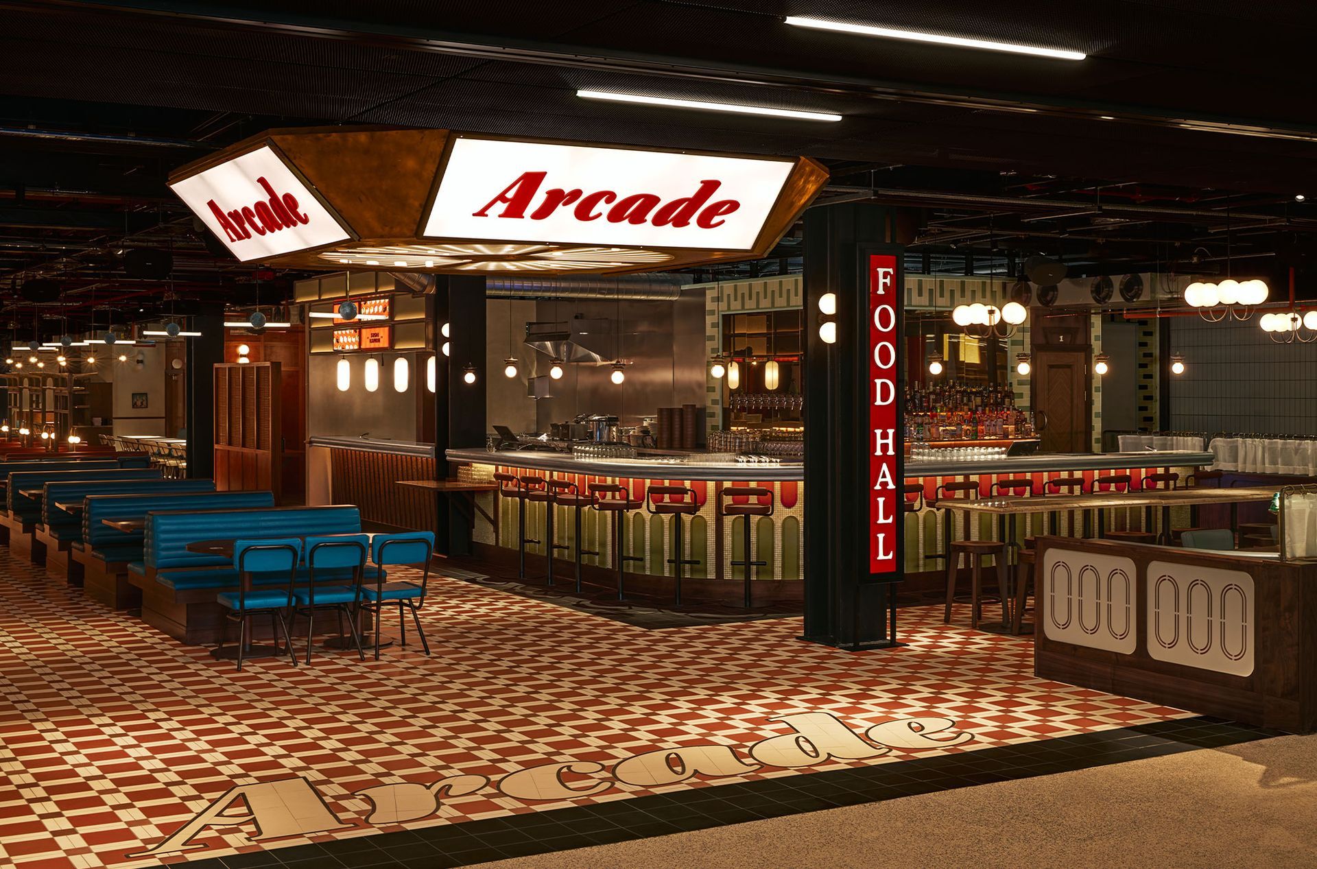 Arcade food hall with mosaic floor pattern and arcade sign