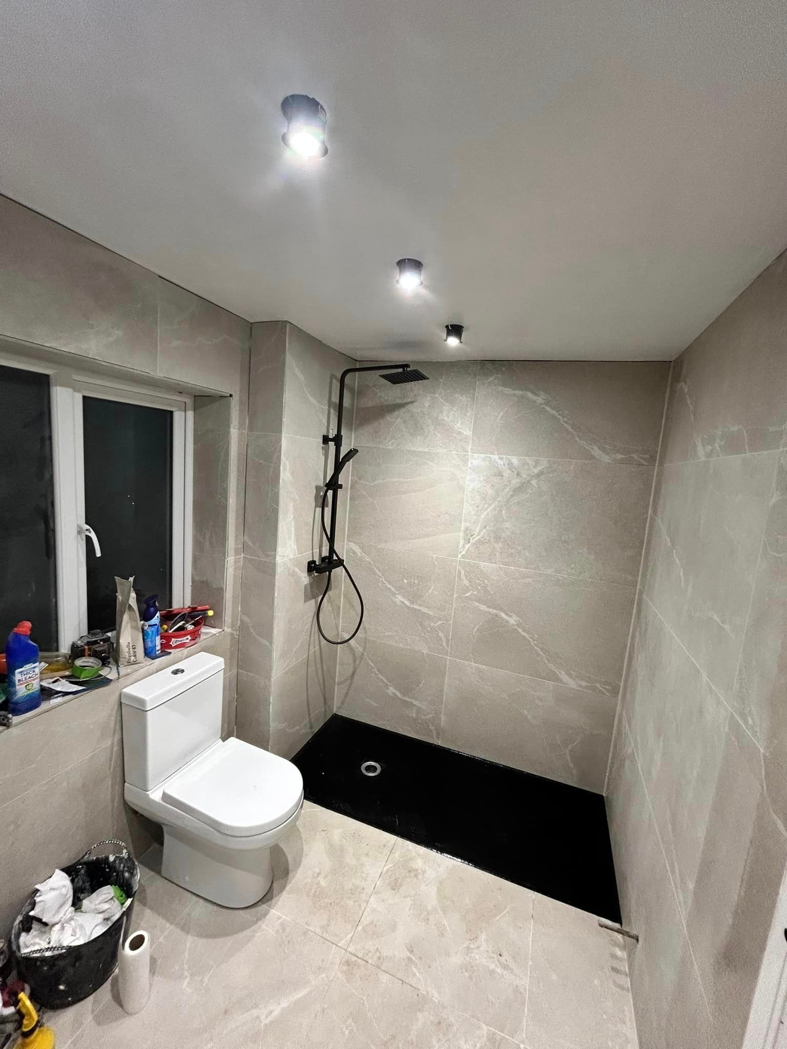 Room shot of marble effect tiles used in a small bathroom