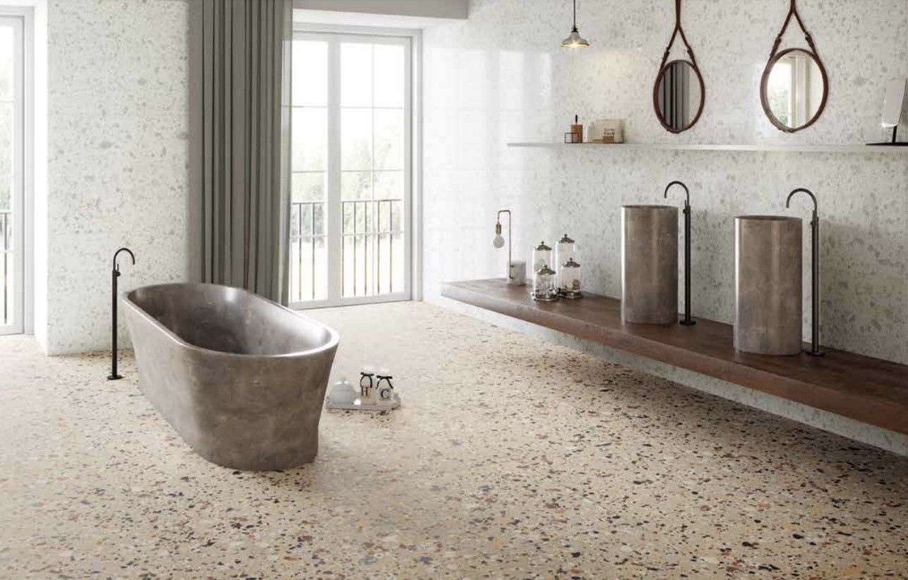 terrazzo tiles used in a bathroom , with metallic accents such as a metal bathtub