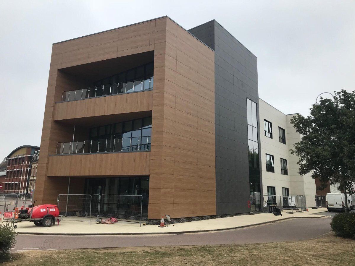 A photo of a building with brown and black extrieor