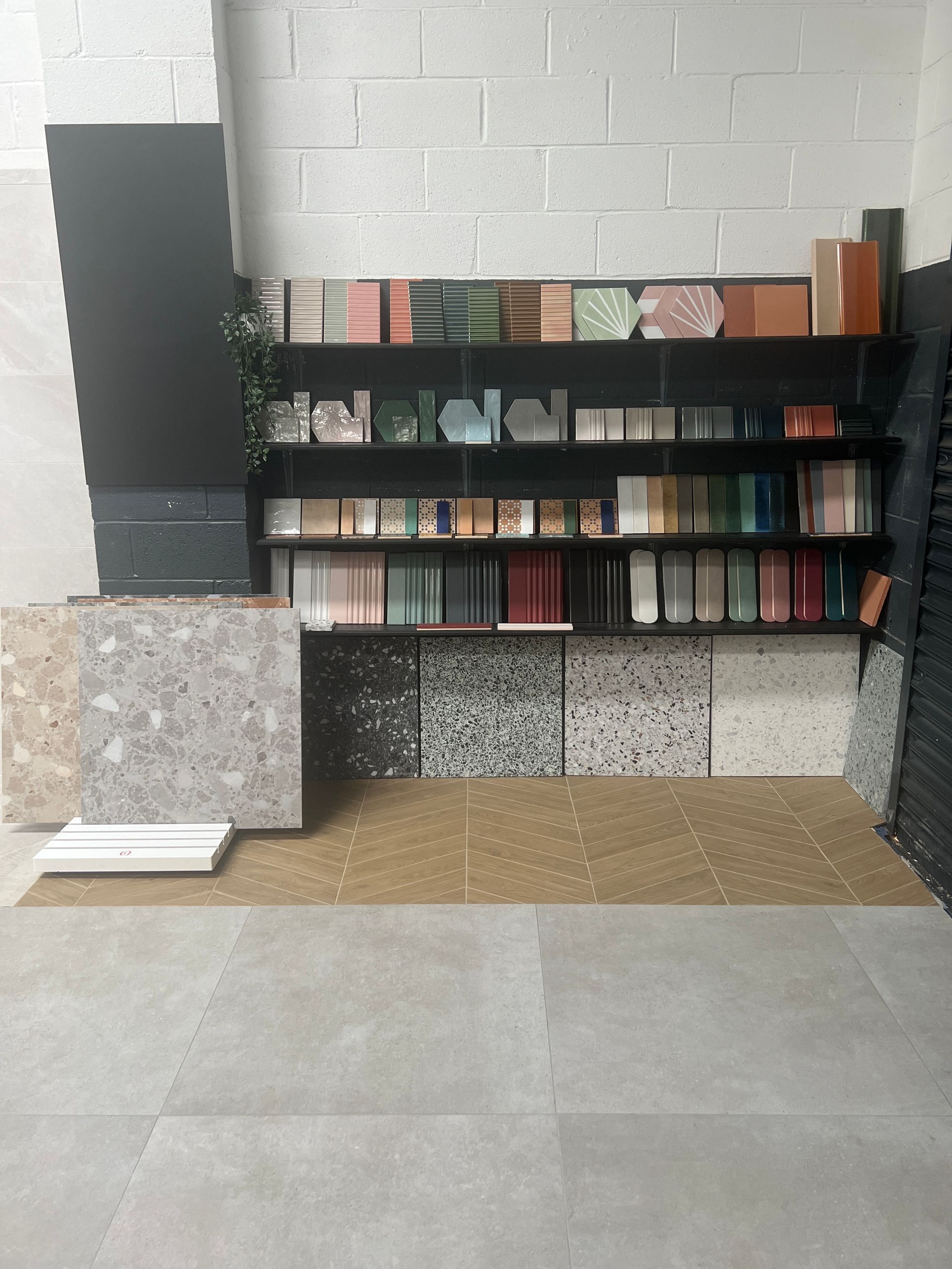 Wall of tiles in our showroom featuring wood effect chevron floor tiles