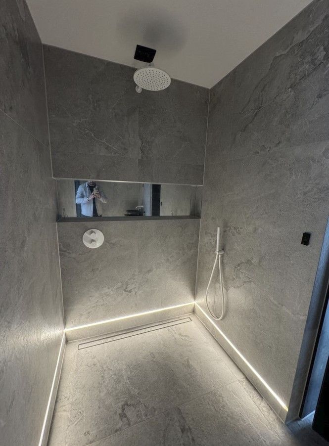LImestone effect bathroom and shower using limestone tiles on the floor and wall