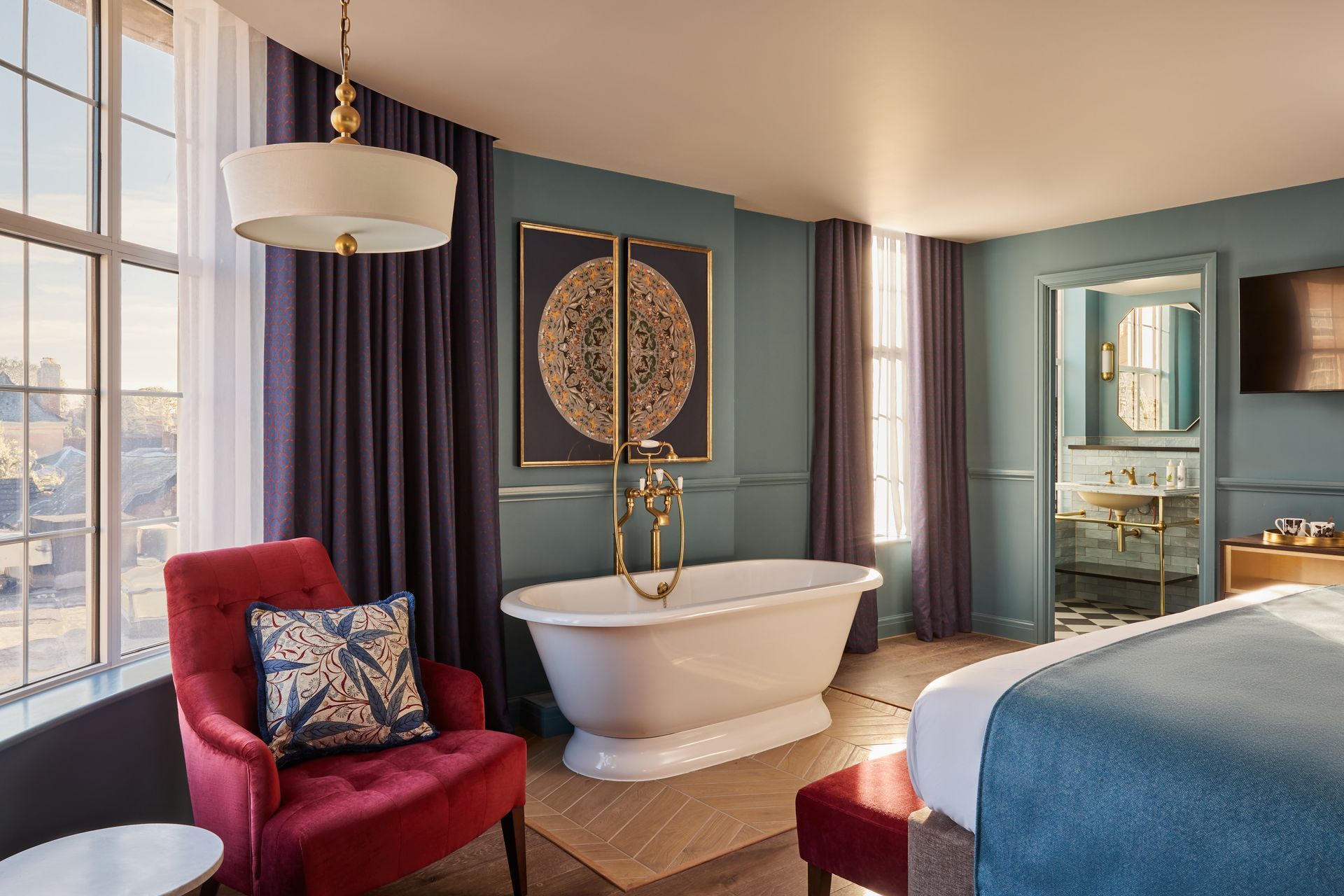 Bedroom with onsuite and chevron wood floor tiles and a bath