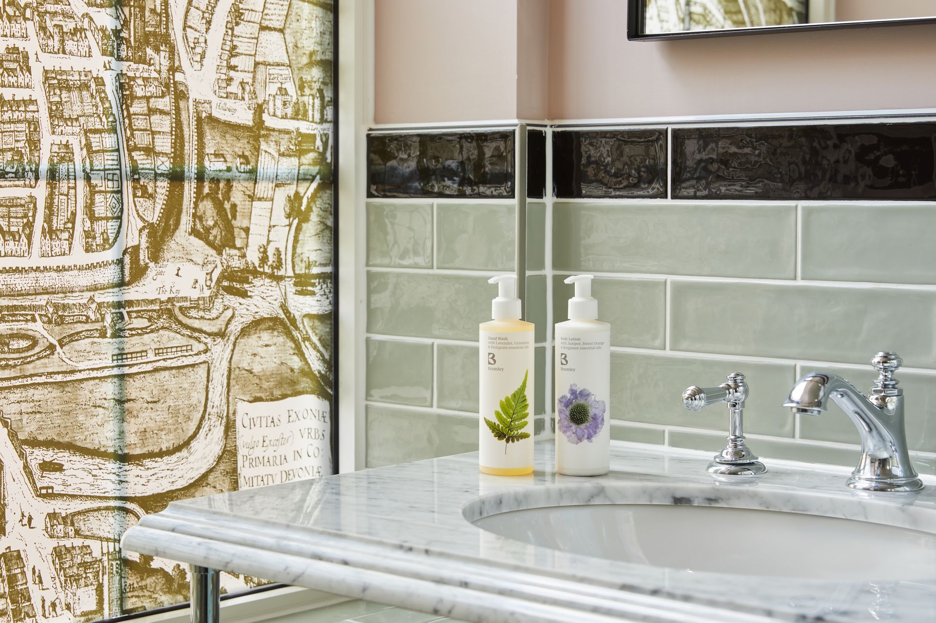 Demure olive on a splashback behind a sink  in bathroom