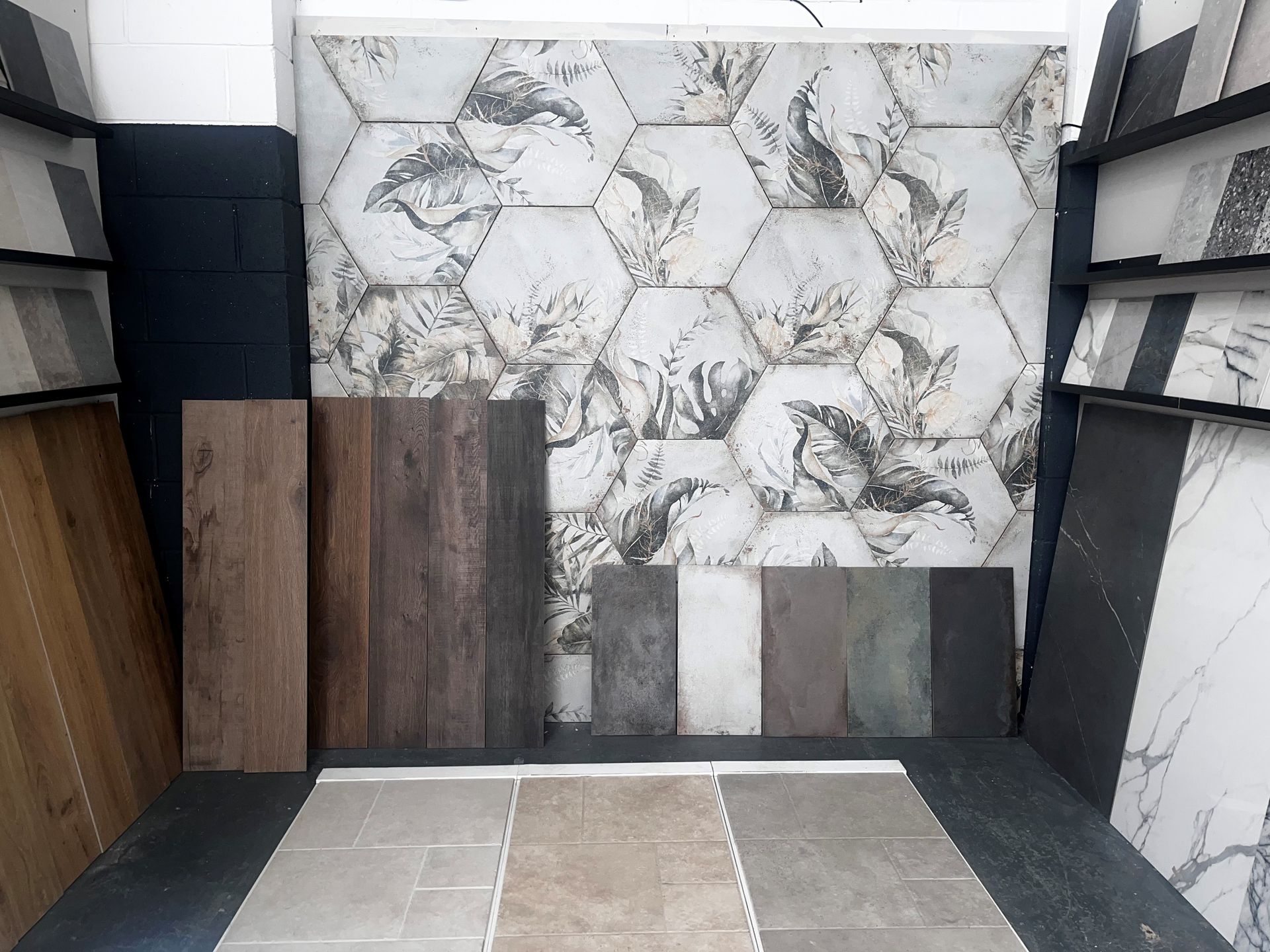 Show room tiles with hexagon décor tiles wood floor tiles and a metallic effect tile