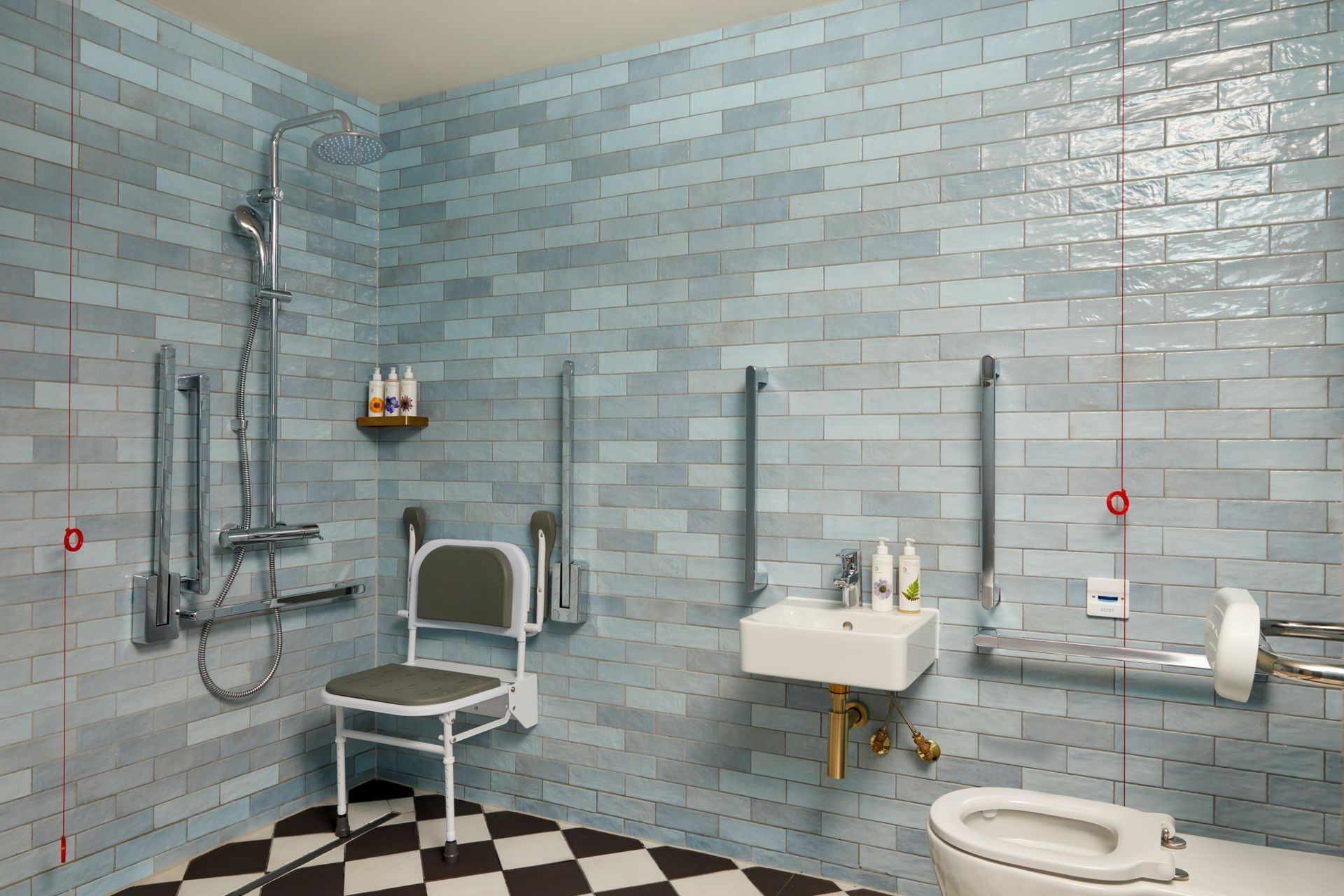 bathroom with demure blue on the wall and chequerboard tiles on the floor